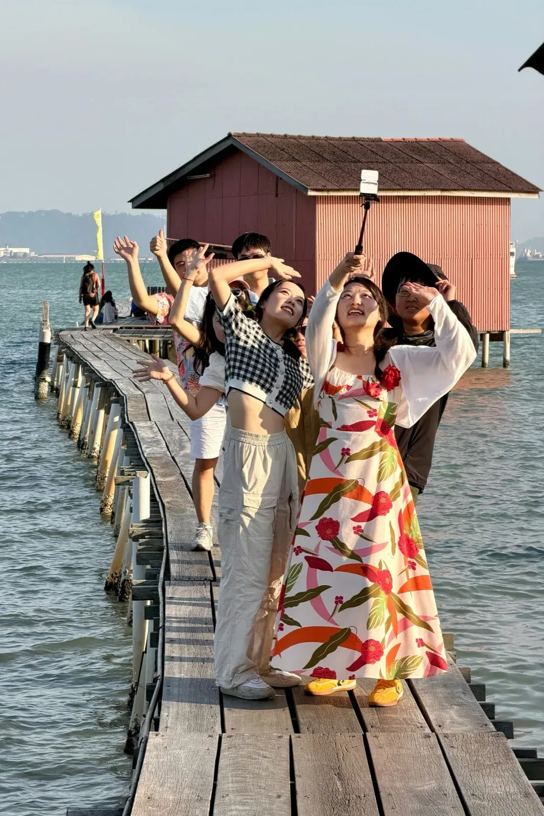 Travellers enjoying a golden-hour moment on a Sri Lankan pier